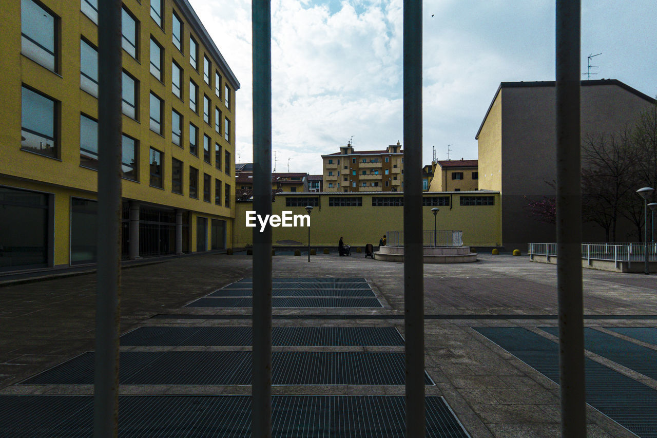 BUILDINGS SEEN THROUGH GLASS WINDOW