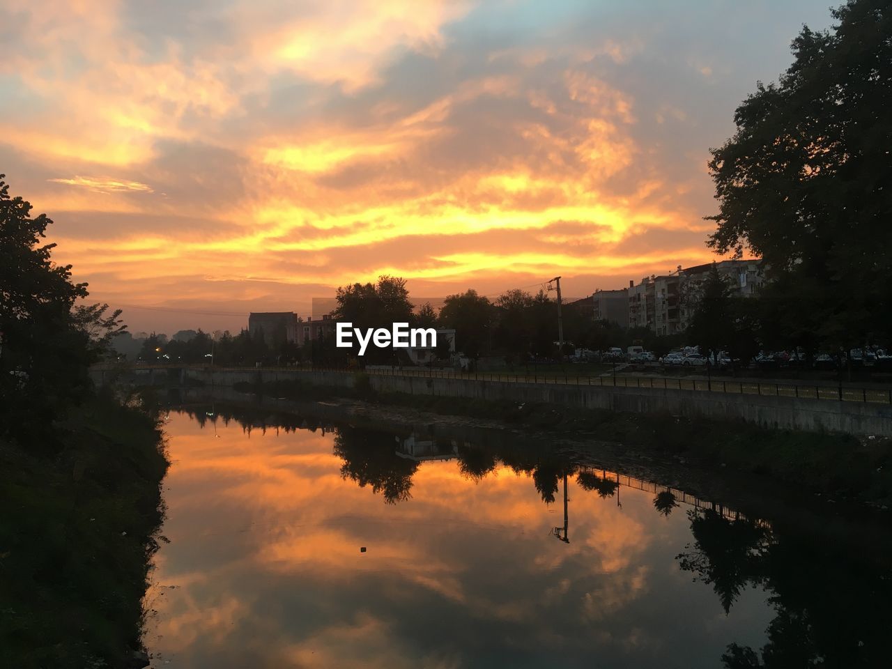 SCENIC VIEW OF LAKE AGAINST ORANGE SKY DURING SUNSET