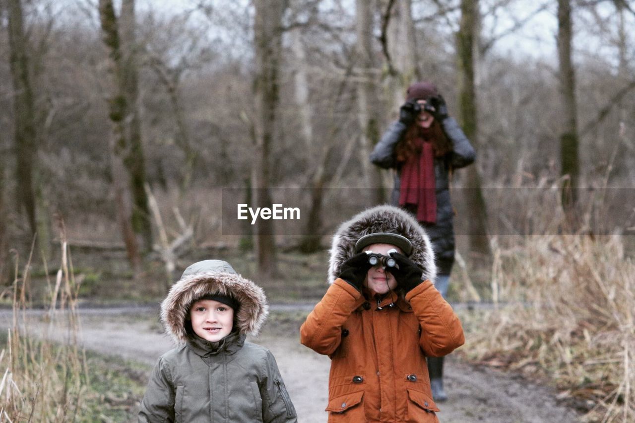 Family standing on road during winter