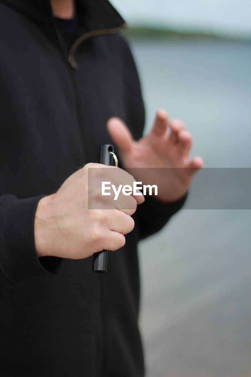 CLOSE-UP OF MAN HOLDING CAMERA