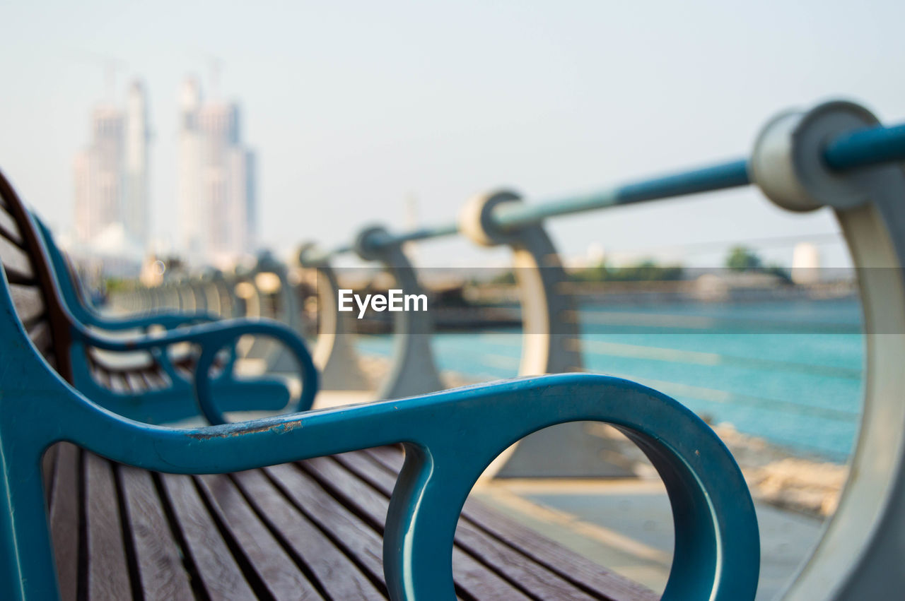 Close-up side view of empty benches