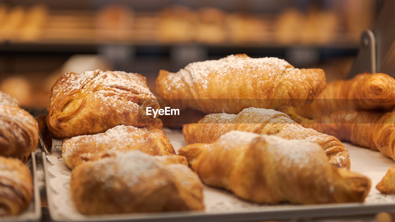 Detail of different pastries behind glass on display in german organic supermarket