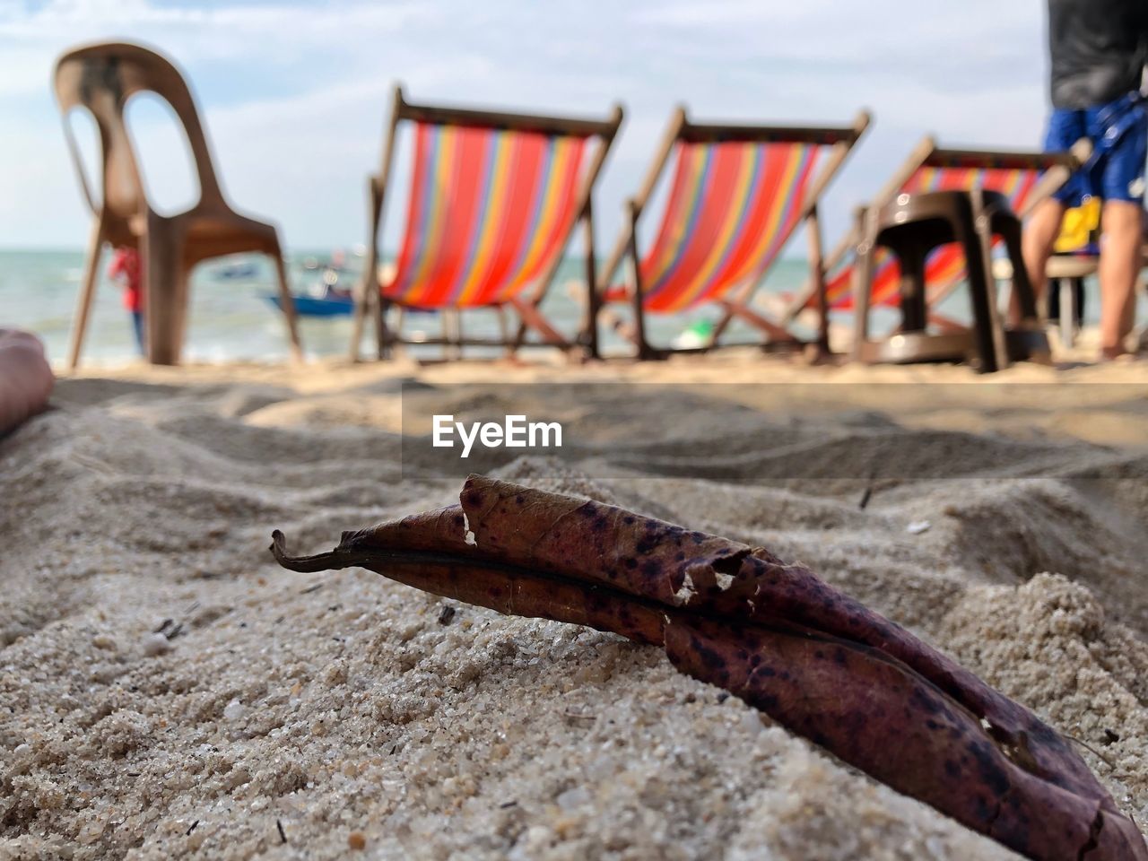 CLOSE-UP OF CHAIR ON BEACH