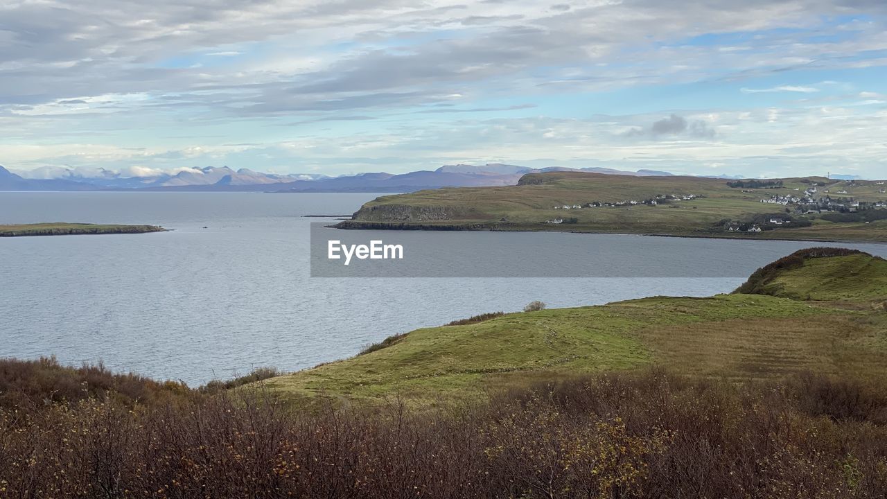 lake, water, scenics - nature, sky, beauty in nature, landscape, environment, reservoir, cloud, nature, land, coast, tranquility, tranquil scene, body of water, shore, mountain, highland, no people, beach, travel destinations, grass, travel, plant, non-urban scene, horizon, day, reflection, tourism, outdoors, coastline, idyllic, bay