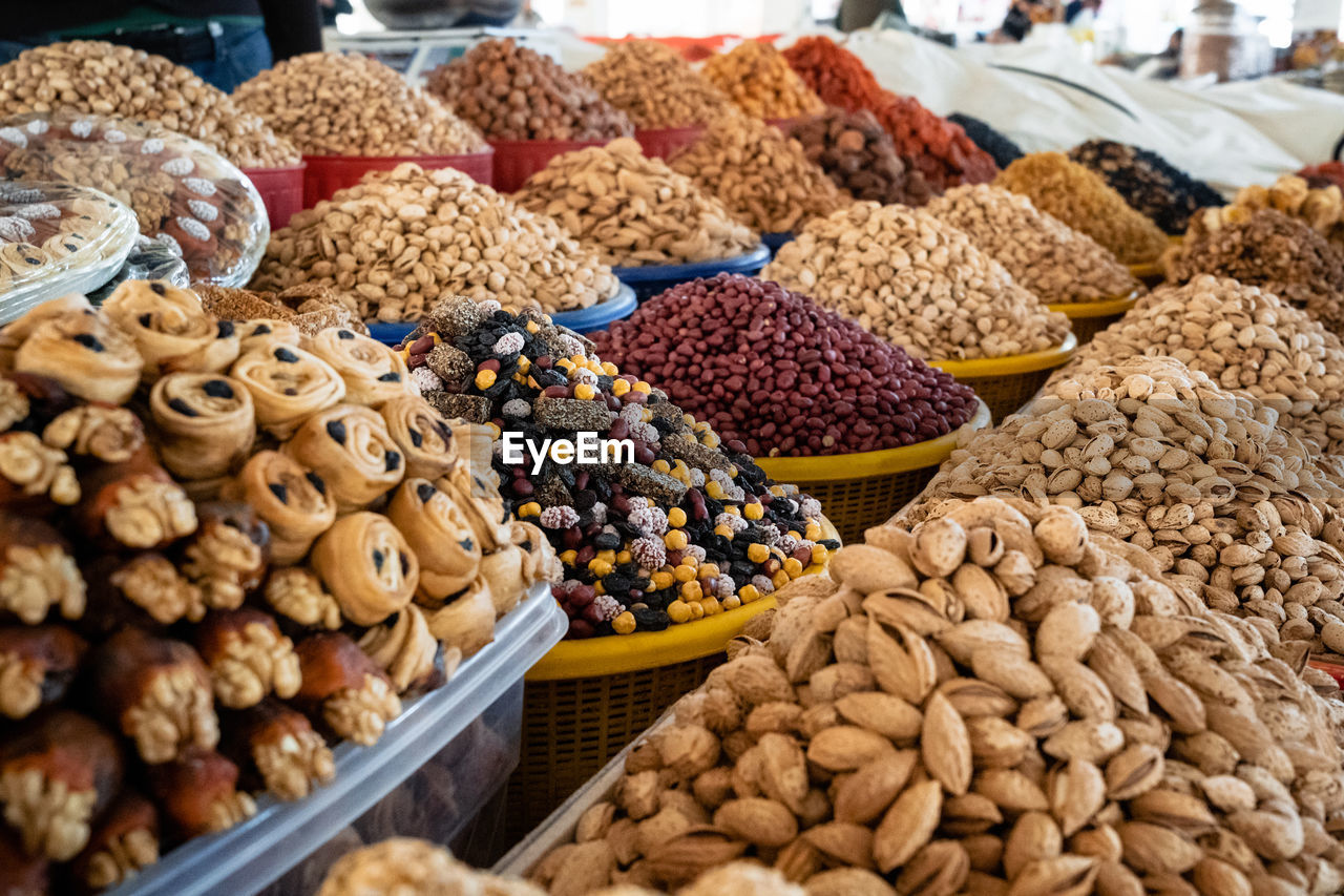 View of colorful sweets and nuts on showcase of local food market, uzbekistan	
