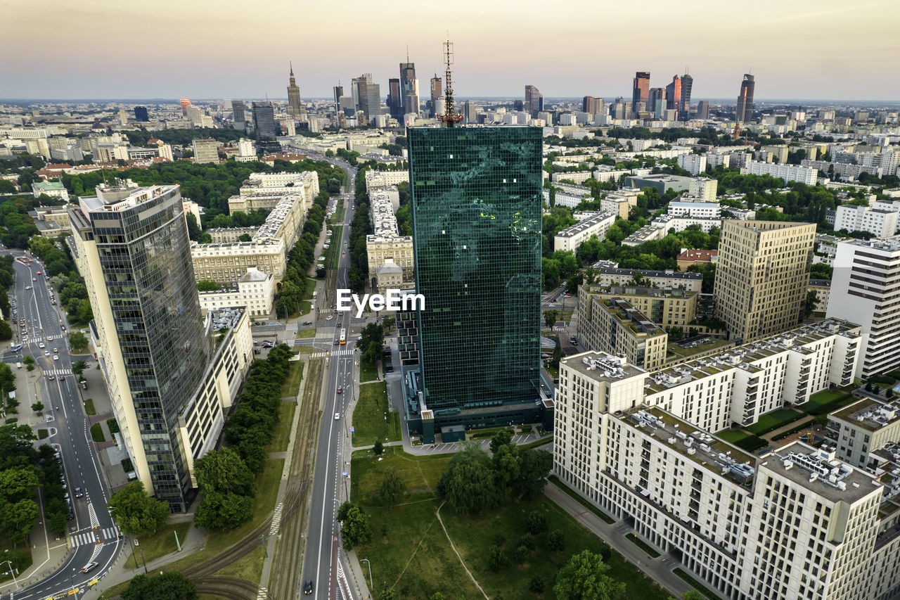 Warsaw, city centre panorama at sunset, business centre 2022. sunset reflected in buildings.