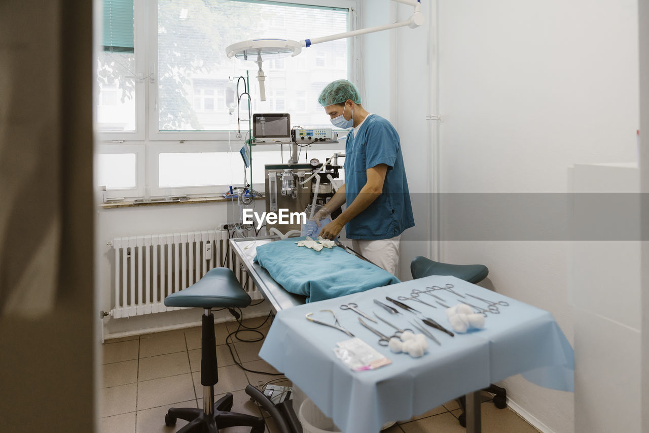 Male veterinarian surgeon preparing for surgery in medical clinic