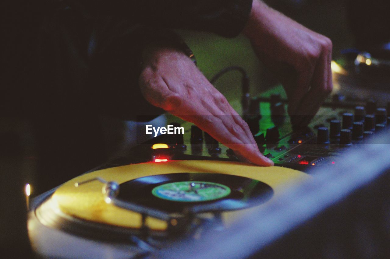 Close-up of club dj playing music on turntable