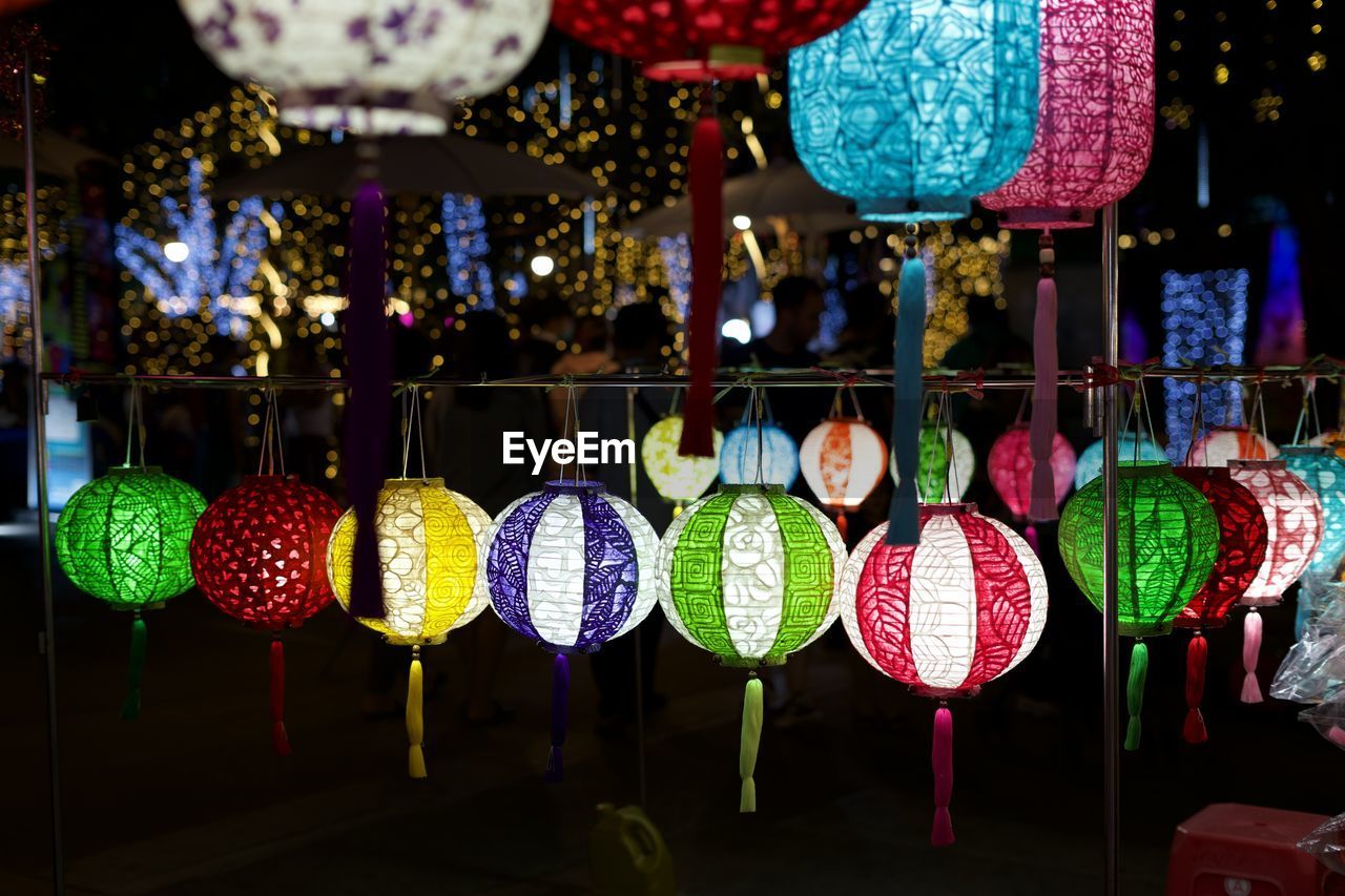 hanging, multi colored, lighting equipment, decoration, night, lantern, retail, celebration, no people, illuminated, large group of objects, market, variation, holiday, for sale, tradition, christmas, market stall, outdoors, store, abundance, chinese lantern, event, business