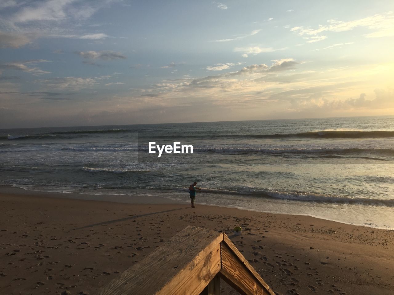 SCENIC VIEW OF BEACH AT SUNSET