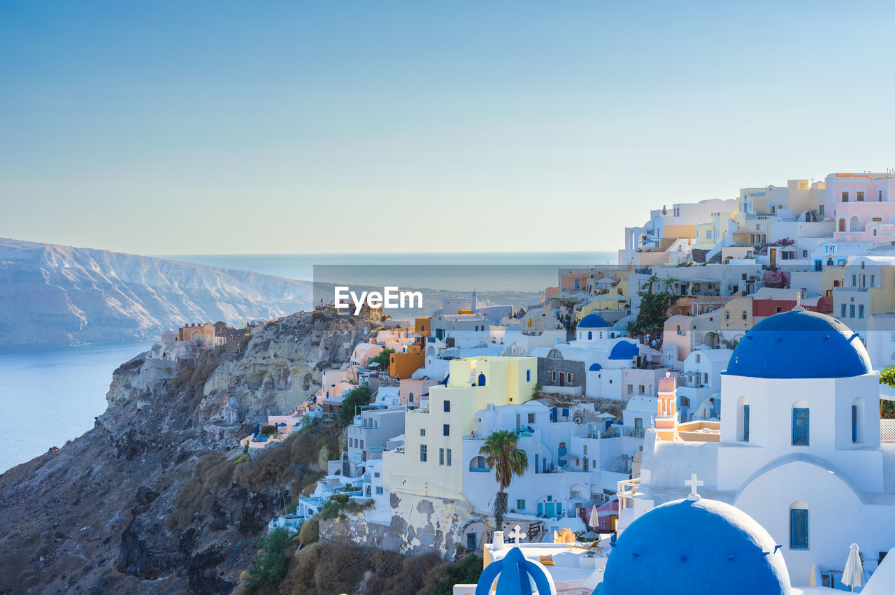 High angle view of santorini, oia townscape by sea against sky. cyclades, greek islands, greece