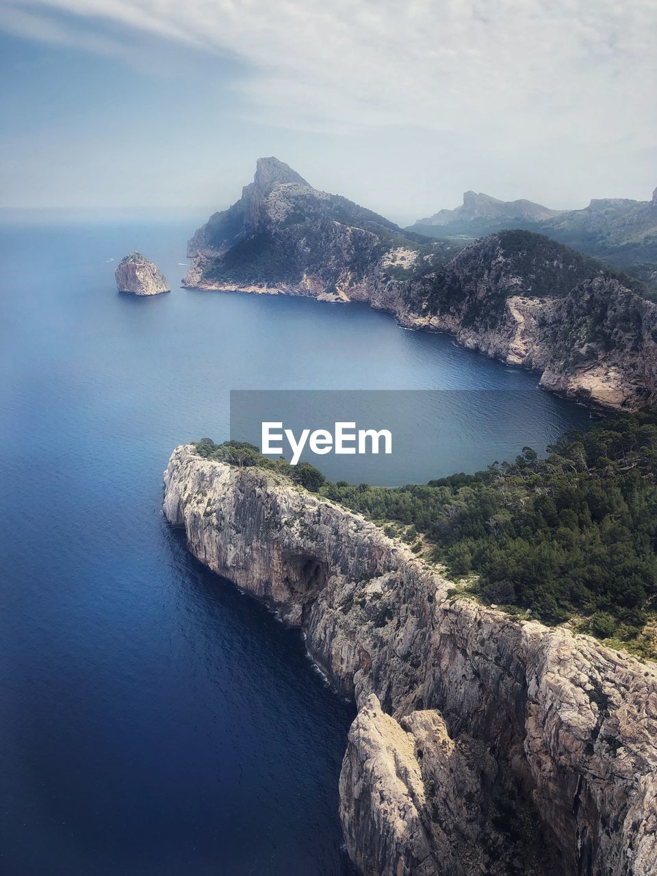 High angle view of rocks by sea against sky