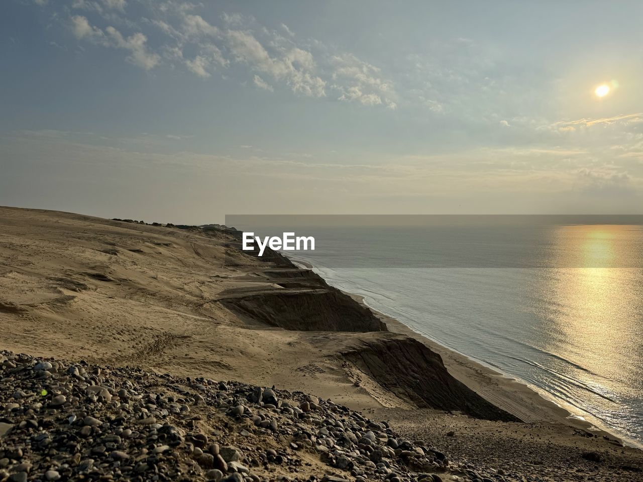 horizon, sky, water, sea, land, beach, scenics - nature, coast, ocean, beauty in nature, nature, shore, tranquility, sunlight, wave, sand, tranquil scene, horizon over water, morning, cloud, environment, dawn, sunrise, no people, landscape, body of water, sun, outdoors, non-urban scene, rock, idyllic, coastline, travel destinations, travel, seascape