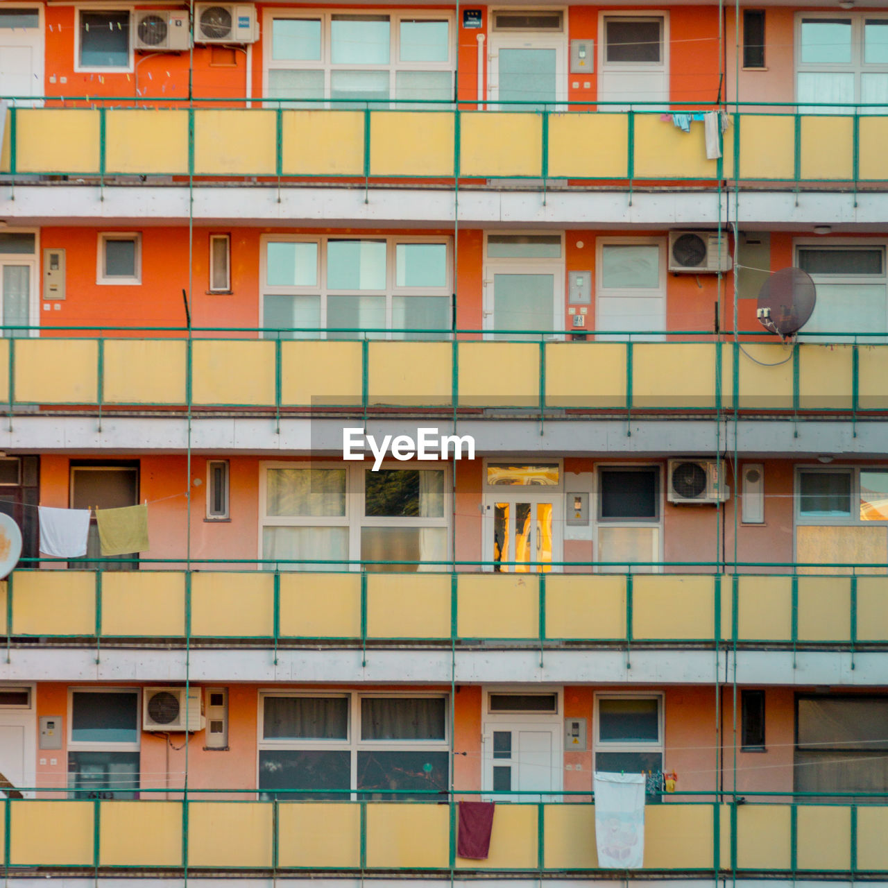 Facade of a building with orange and green balcony
