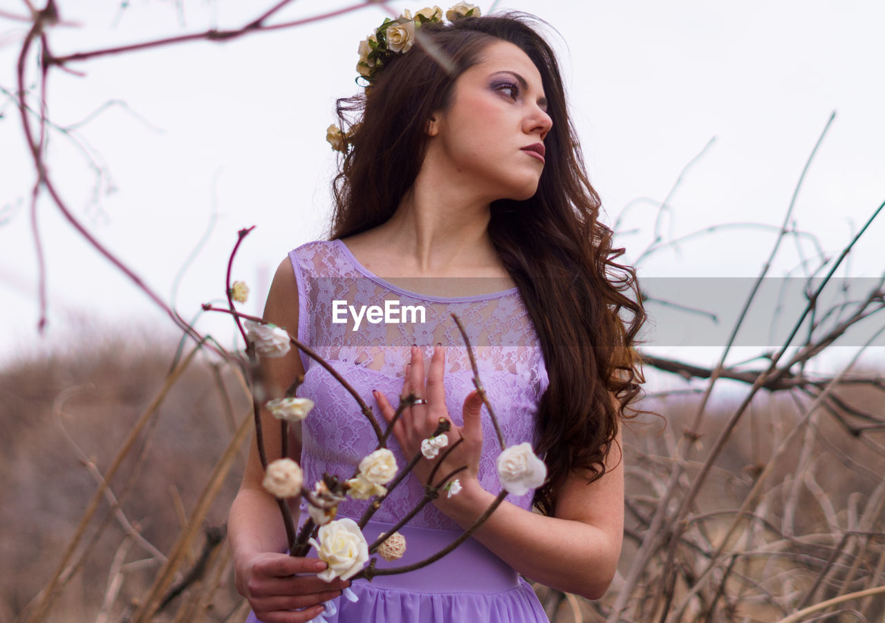 Portrait of young woman standing outdoors