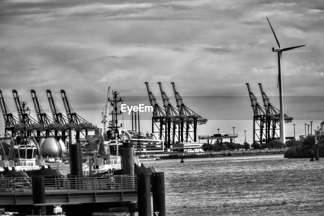 High angle view of harbor against cloudy sky