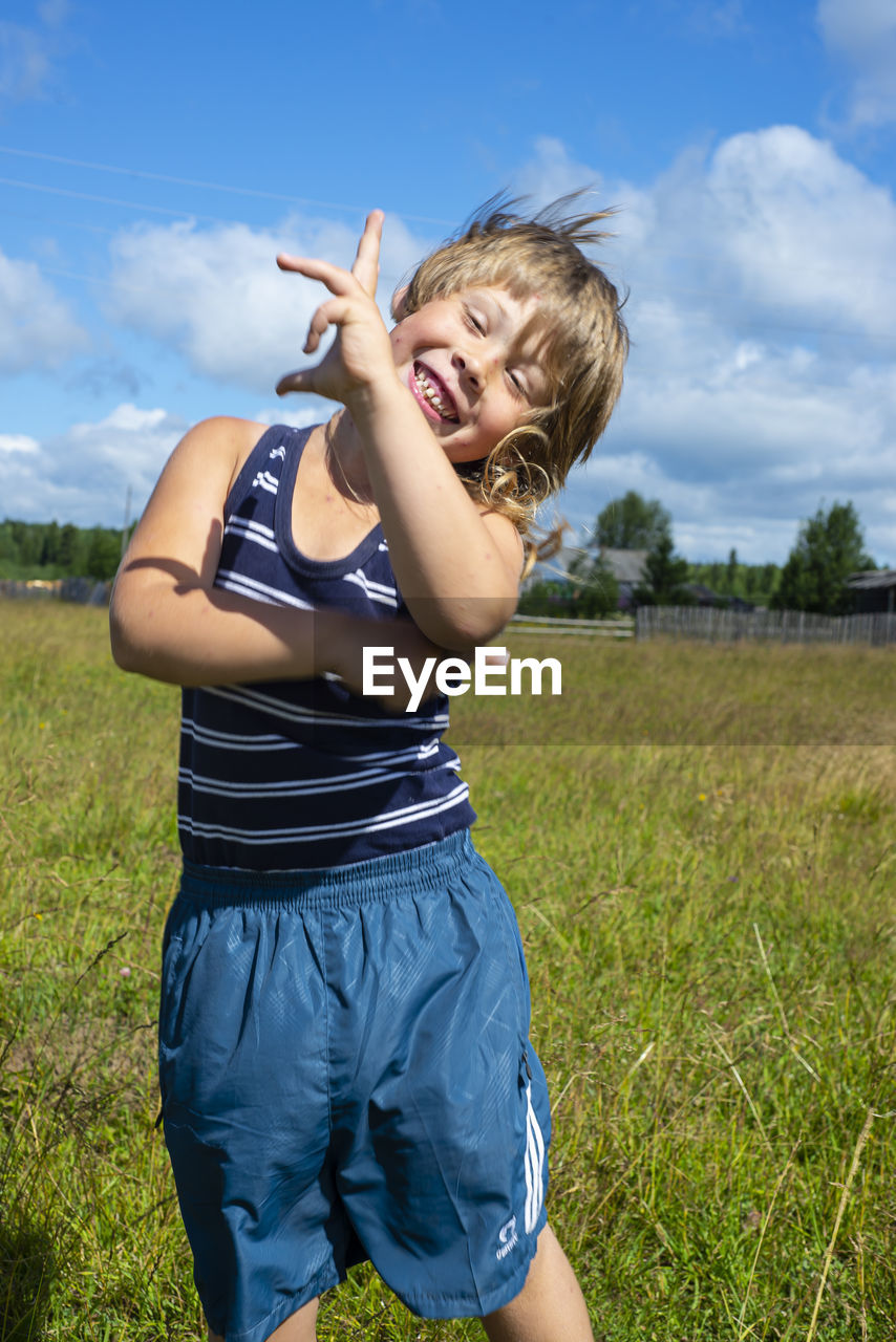 The boy is having fun, dancing, fooling around. positive emotions. joy.