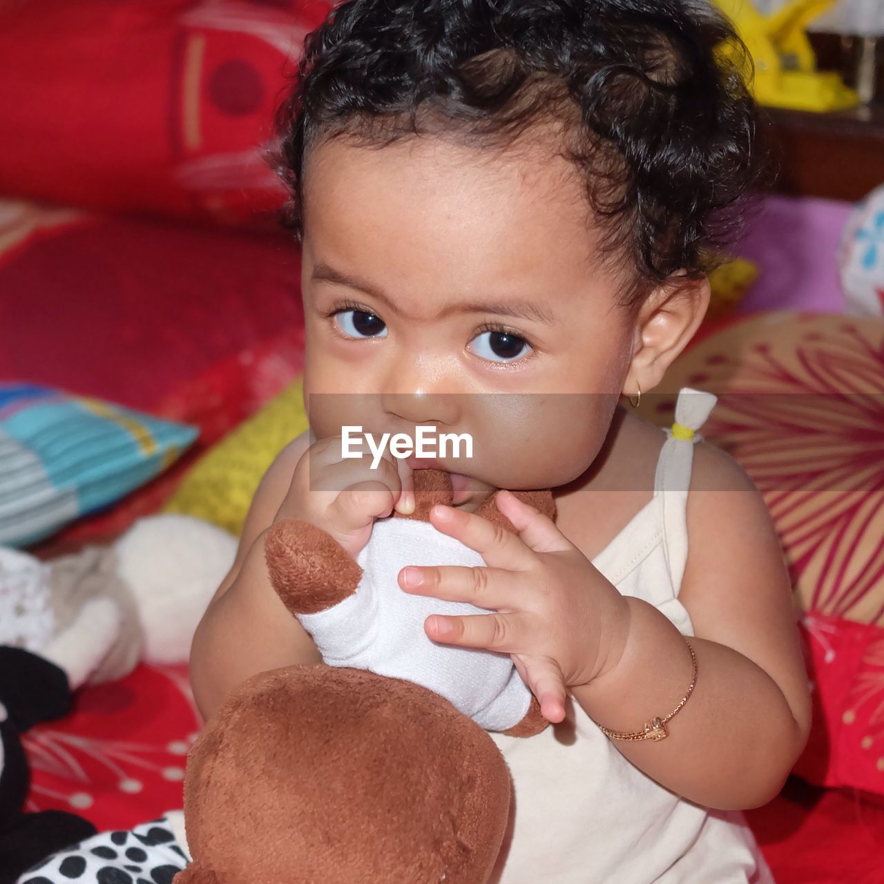 CLOSE-UP PORTRAIT OF CUTE BABY GIRL IN BED