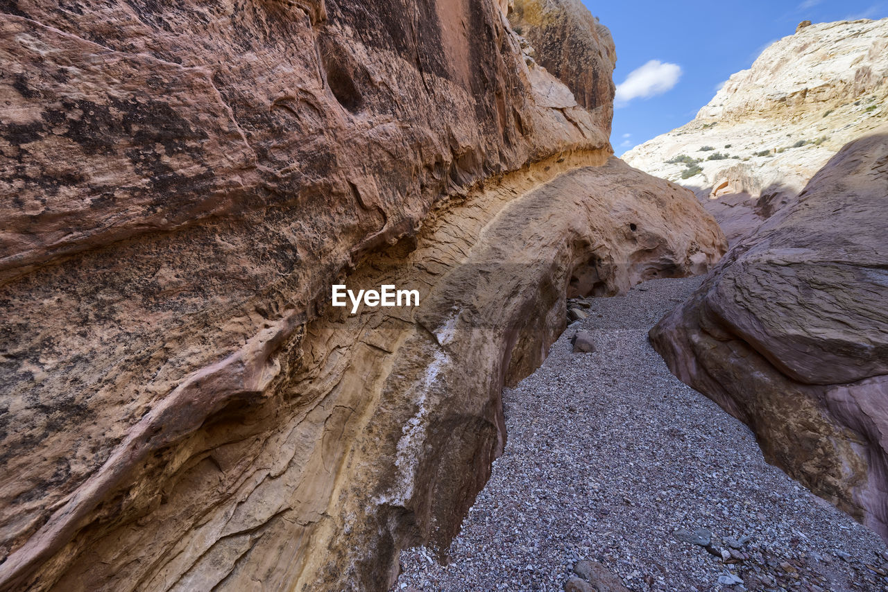 LOW ANGLE VIEW OF ROCK FORMATIONS IN MOUNTAINS