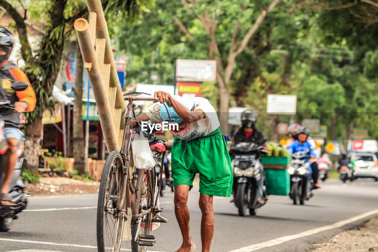 Rear view of people walking on road