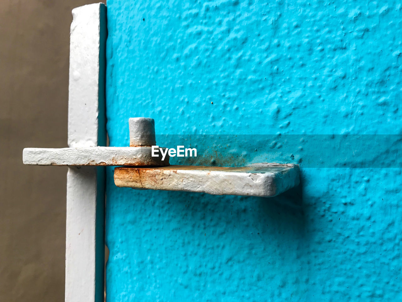 Close-up of metal on blue wall