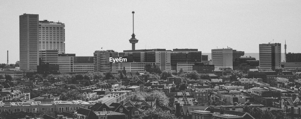 View of skyscrapers in city against clear sky