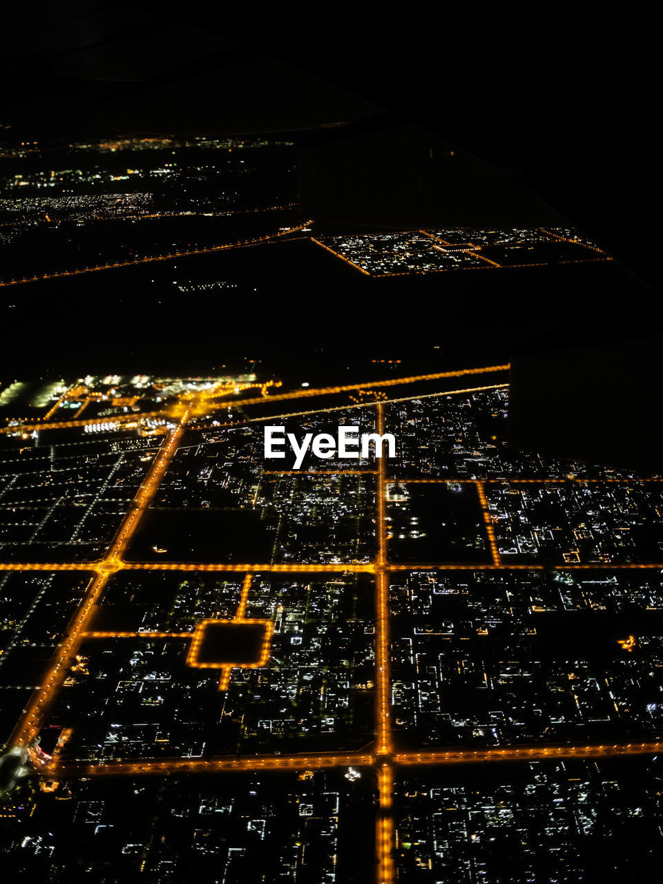 Illuminated cityscape against sky at night