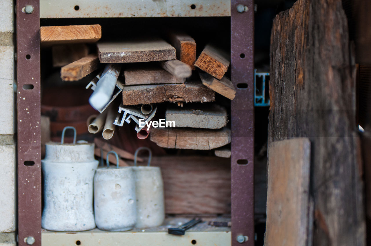 Wooden planks and work tools on metallic shelf