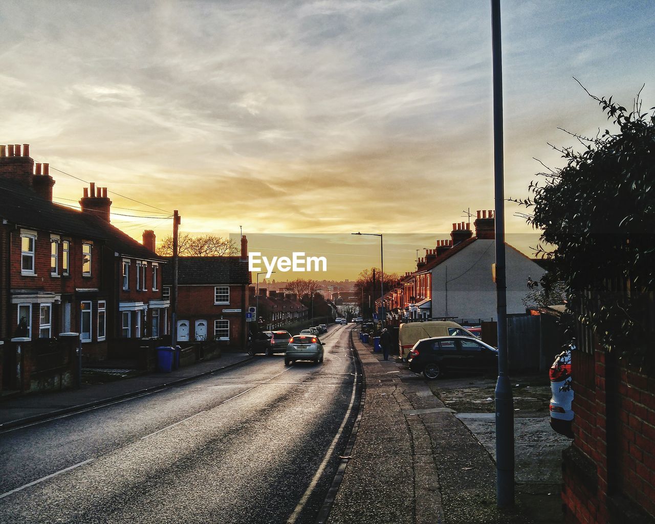 CARS ON ROAD AGAINST SKY IN CITY