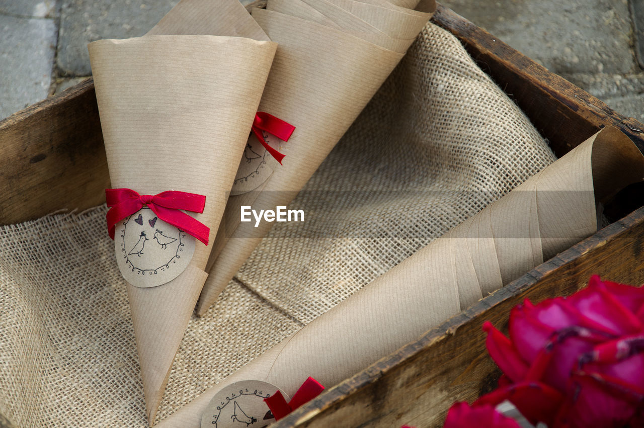 High angle view of cone shaped brown papers in wooden crate