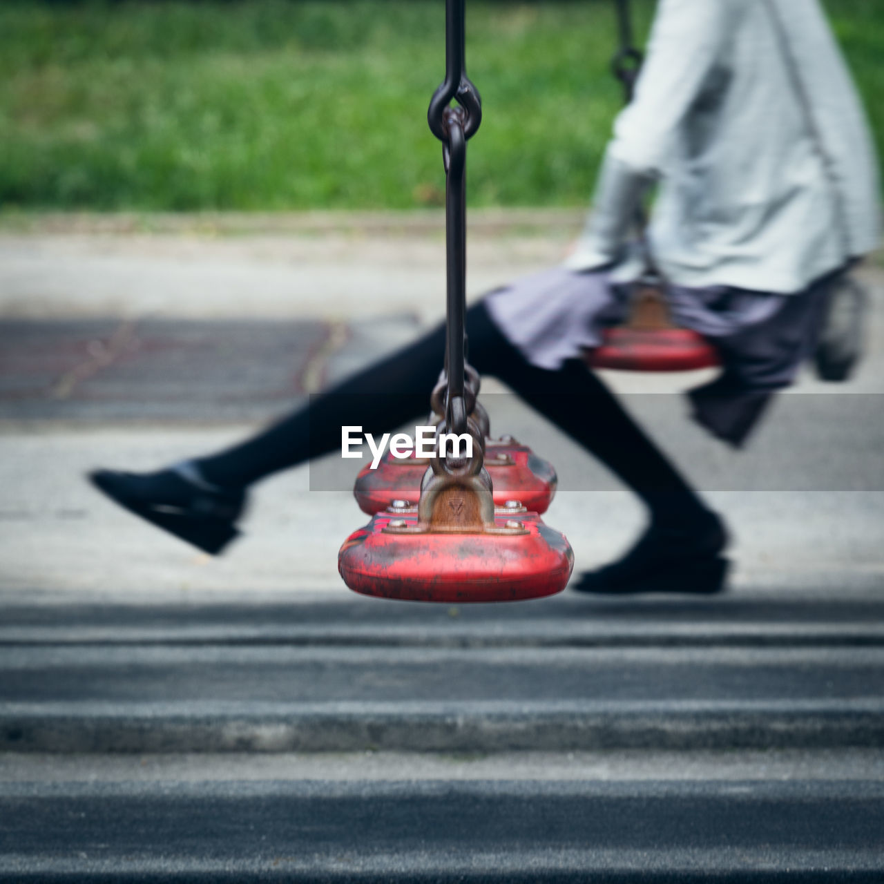 Low section of woman om swing in park