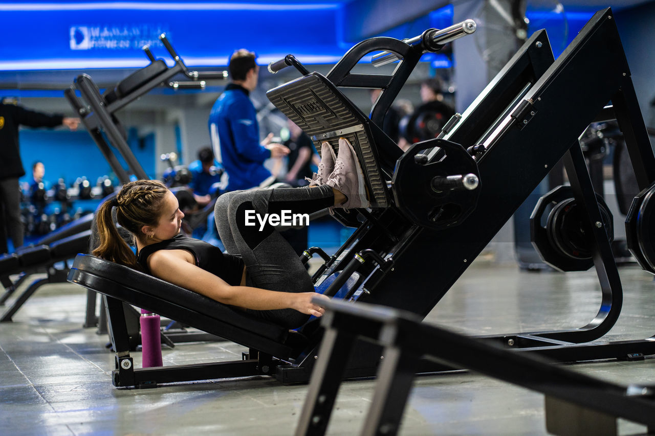 Young woman exercising in gym