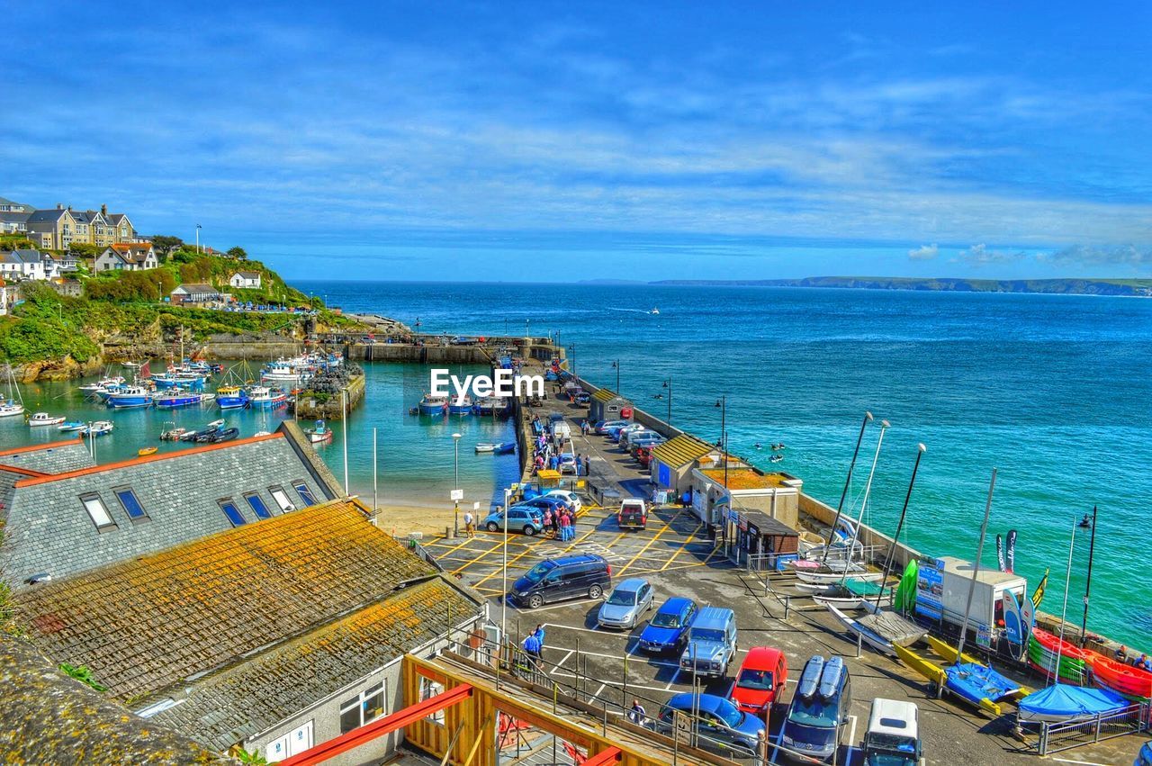 High angle view of ship moored at harbor against sky