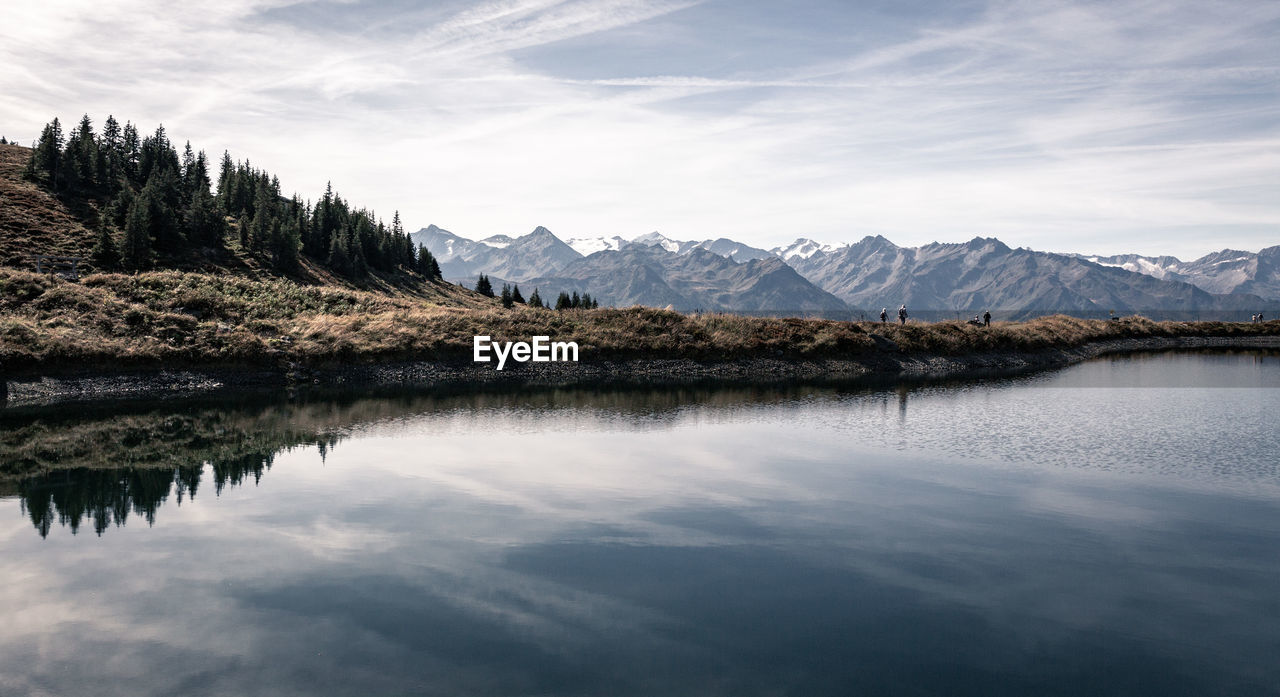 Scenic view of lake and mountains against sky