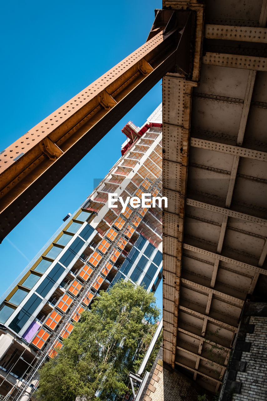 architecture, built structure, building exterior, urban area, city, sky, building, nature, landmark, clear sky, low angle view, no people, blue, industry, skyscraper, outdoors, day, construction industry, residential district, facade, travel destinations, business