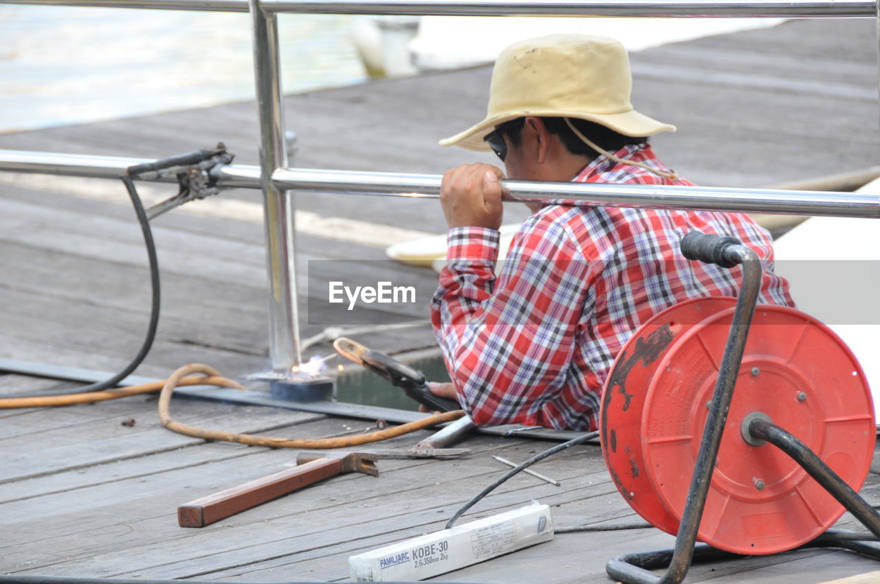 Side view of mid adult man working in factory