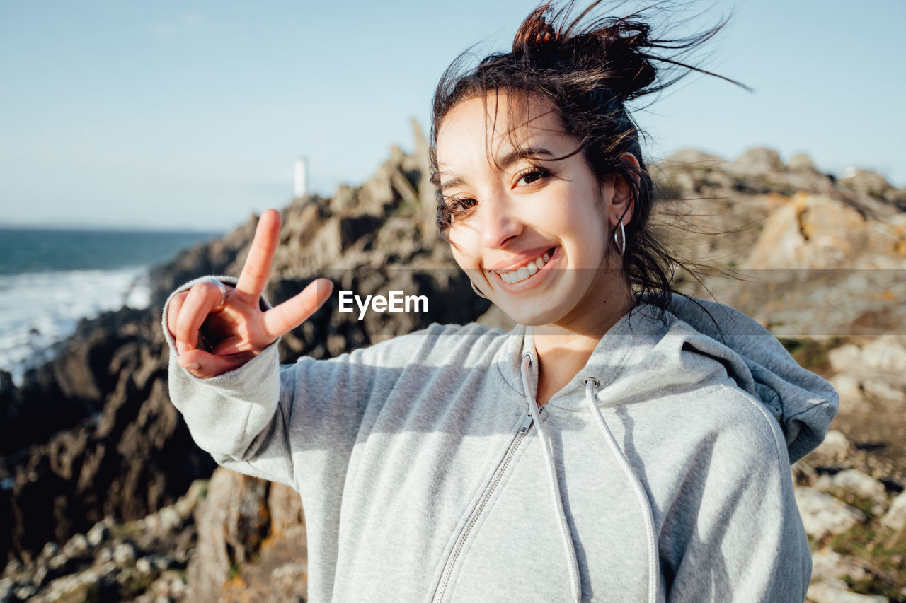 Portrait of smiling young woman using mobile phone