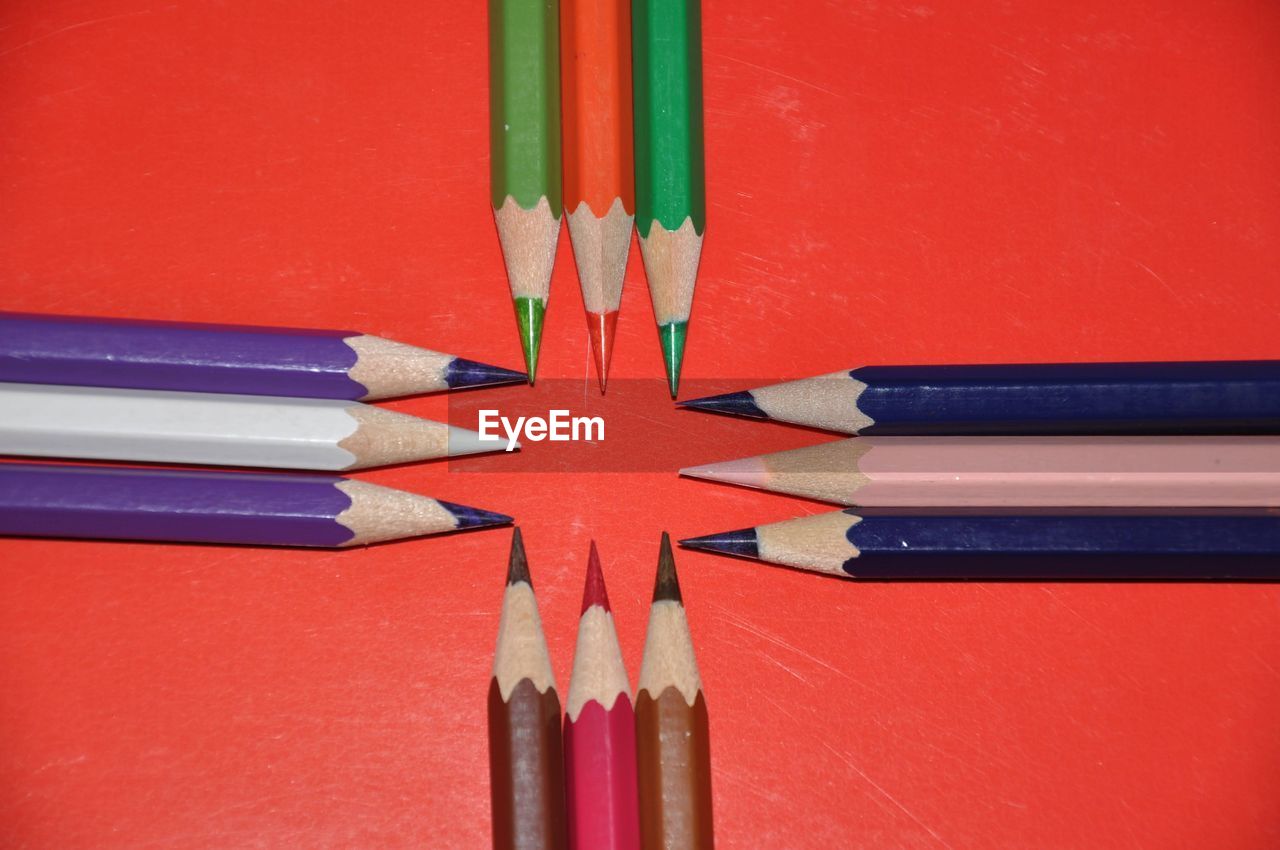 high angle view of colored pencils against yellow background