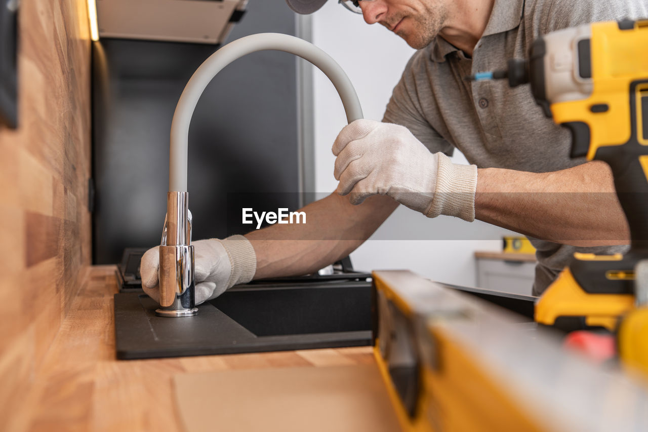 midsection of man working at table