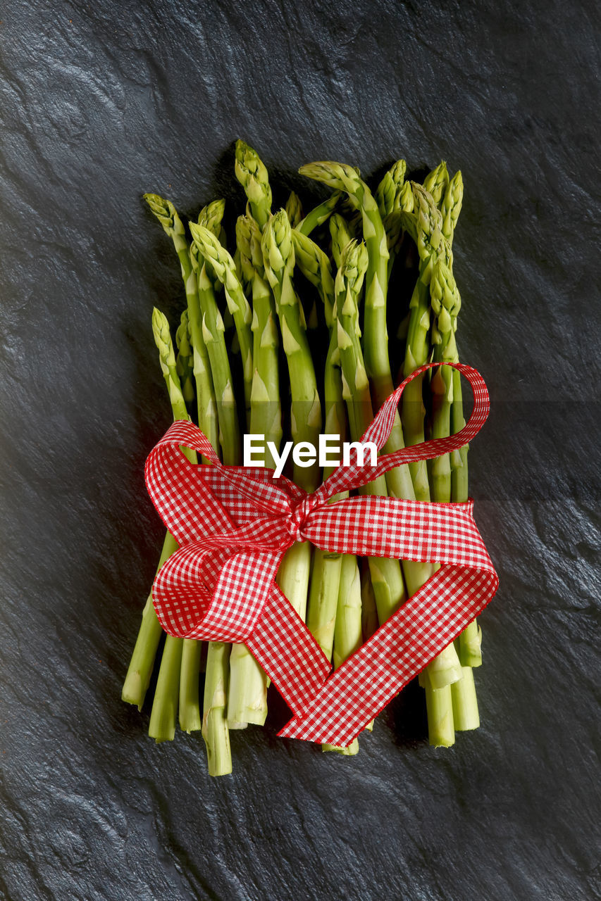 HIGH ANGLE VIEW OF FRESH VEGETABLES ON TABLE AGAINST GRAY BACKGROUND