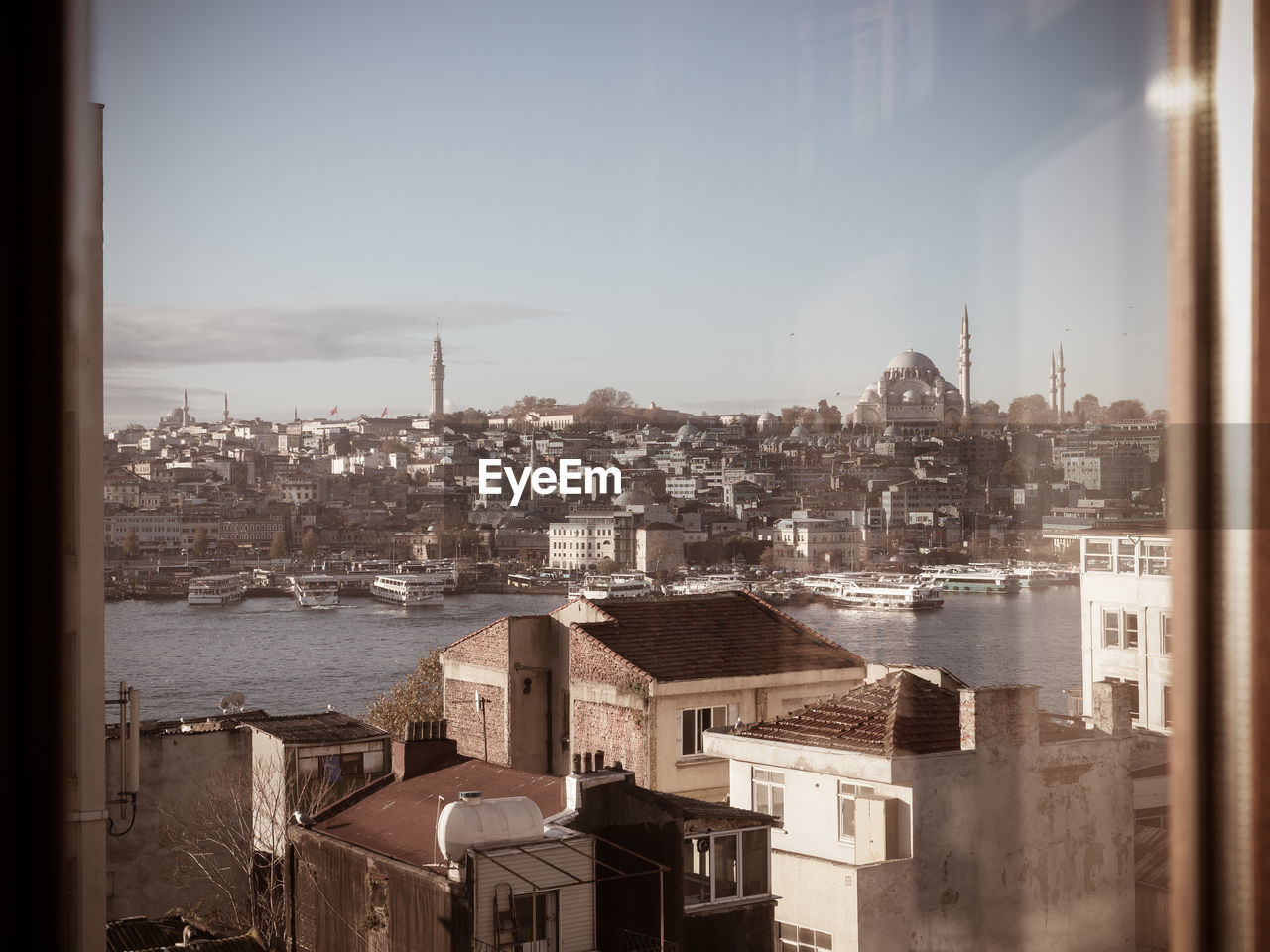 Through window view of istanbul old city and golden horn in sunrise.