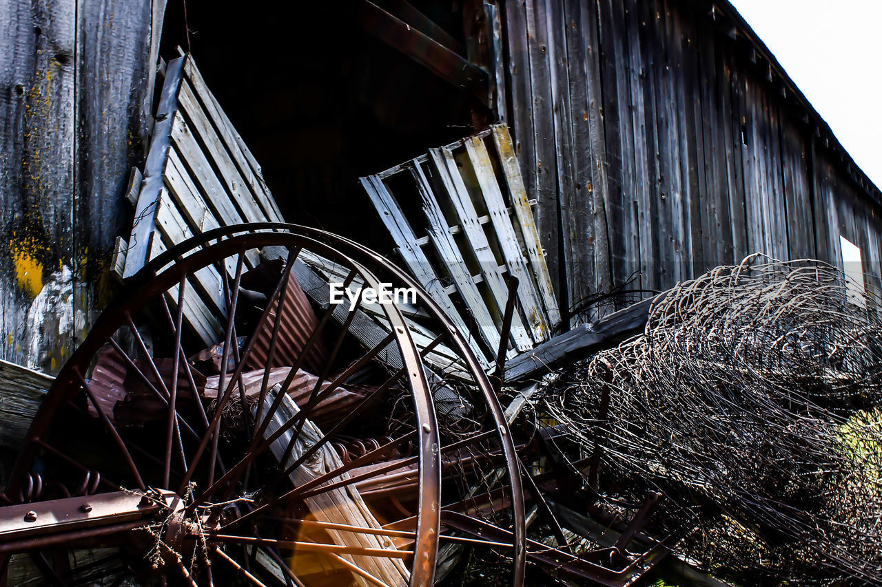 Metallic scrap against abandoned barn