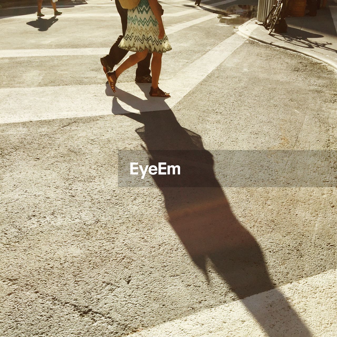 Low section of man and woman walking on street