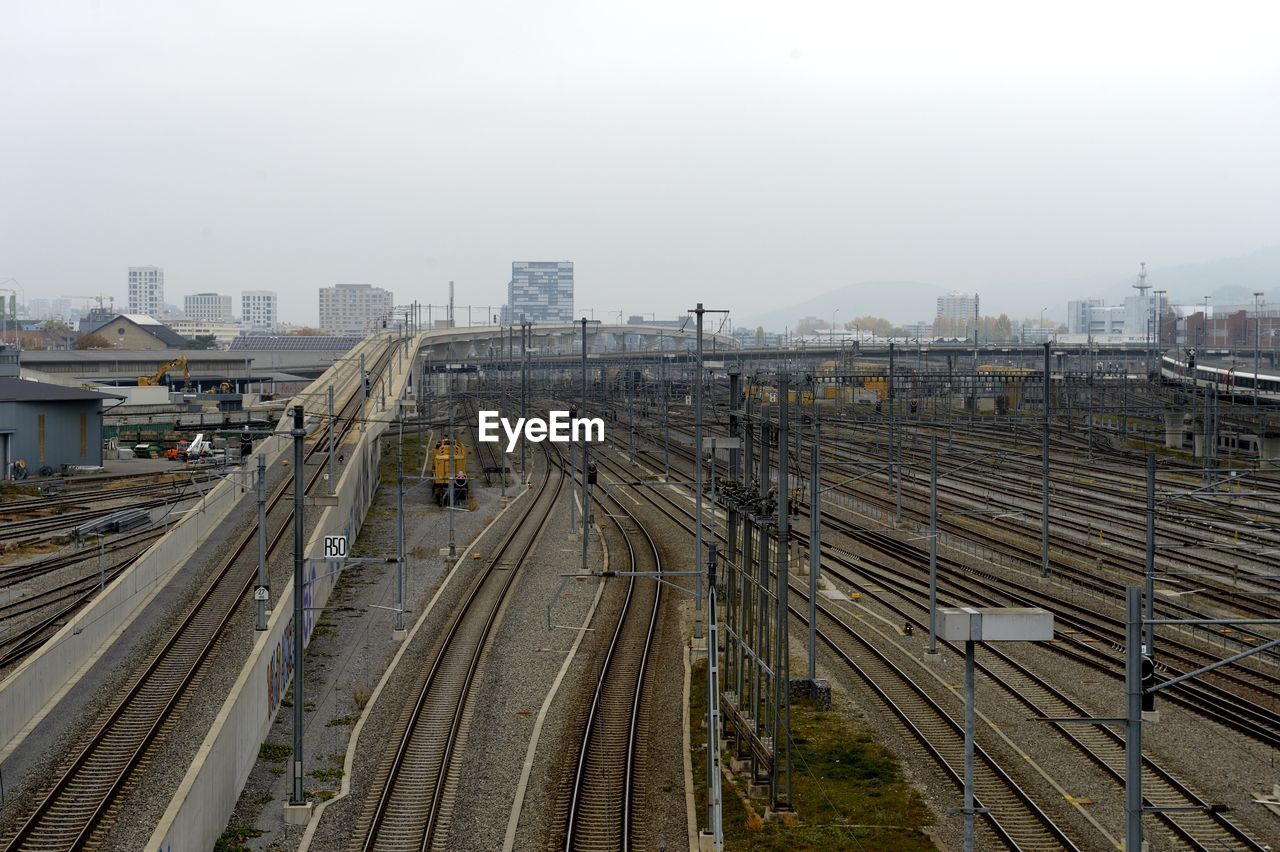 HIGH ANGLE VIEW OF RAILROAD TRACKS AGAINST SKY