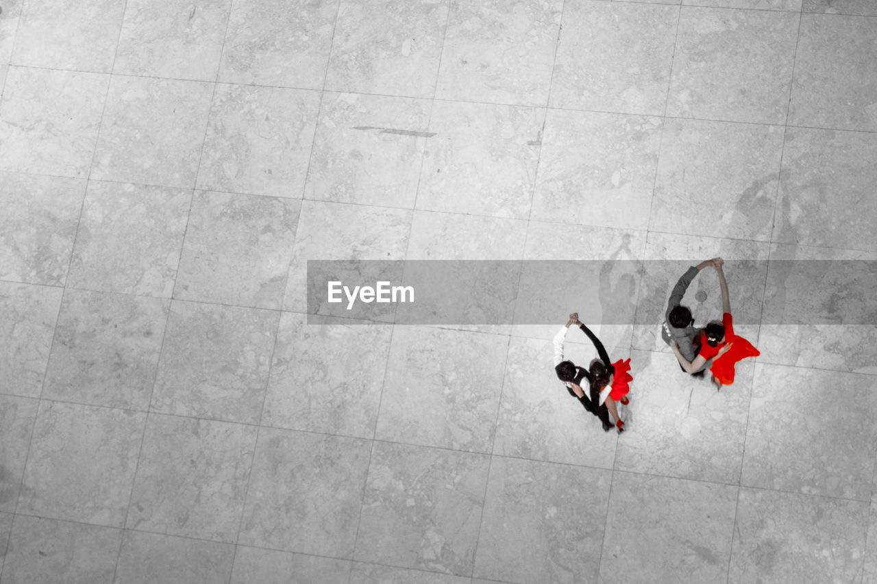 High angle view of couple dancing on tiled floor