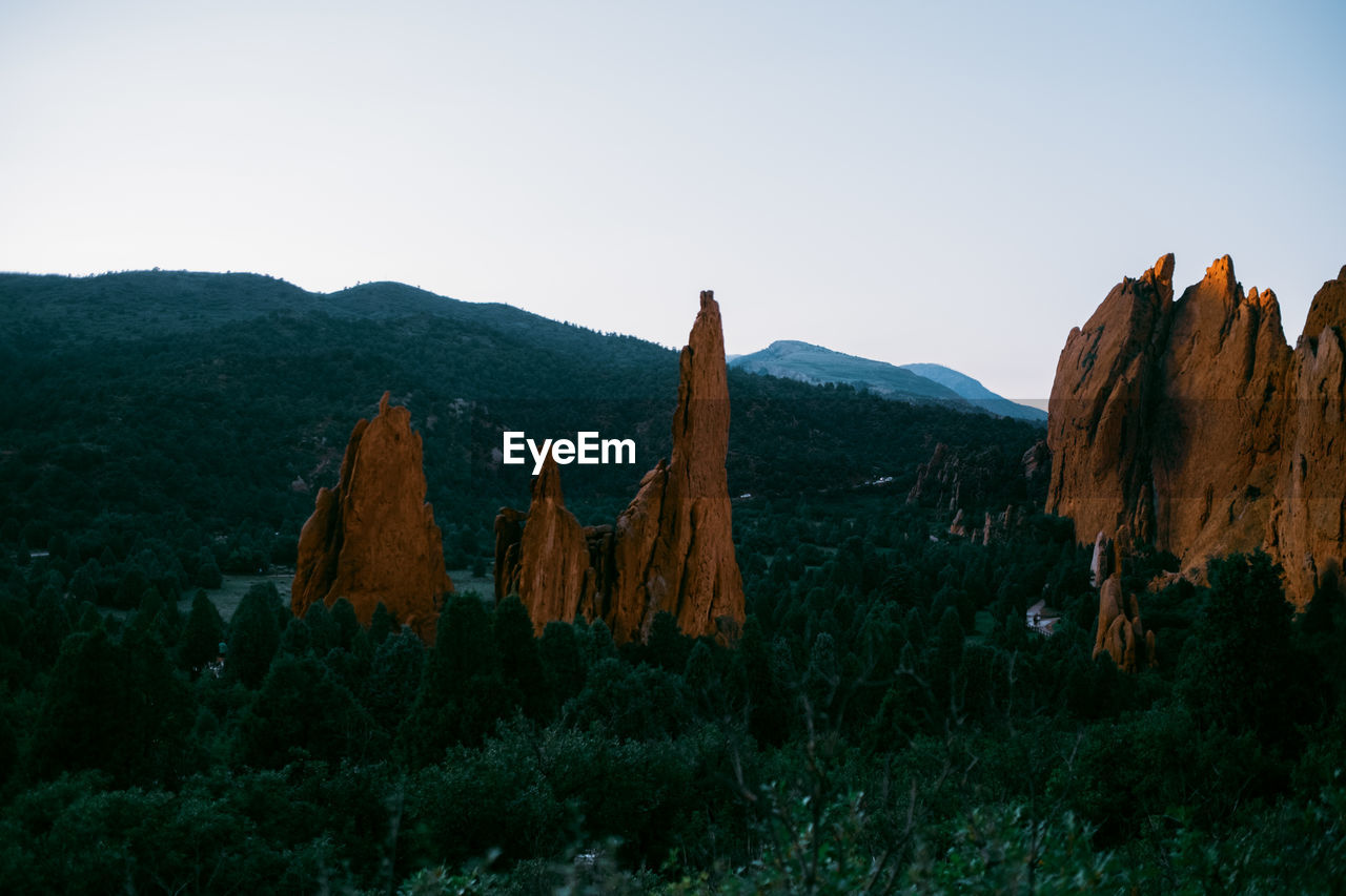 Panoramic view of rocky mountains against clear sky