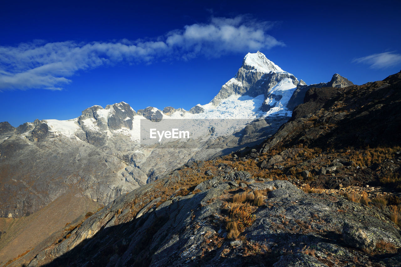 View of mountain peaks with snow against sky