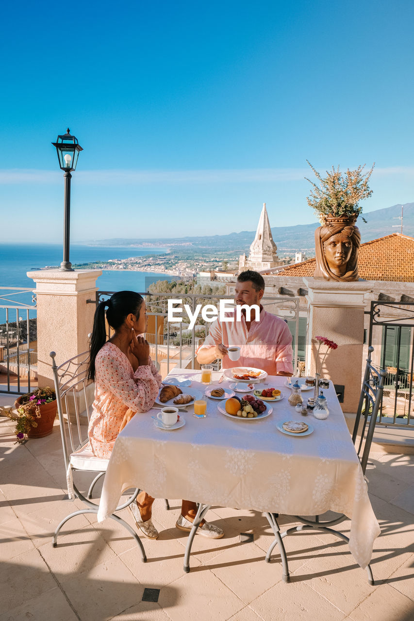 PEOPLE SITTING ON TABLE AT RESTAURANT