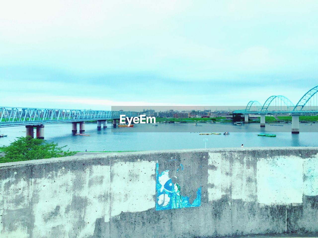 VIEW OF BRIDGE OVER CALM RIVER