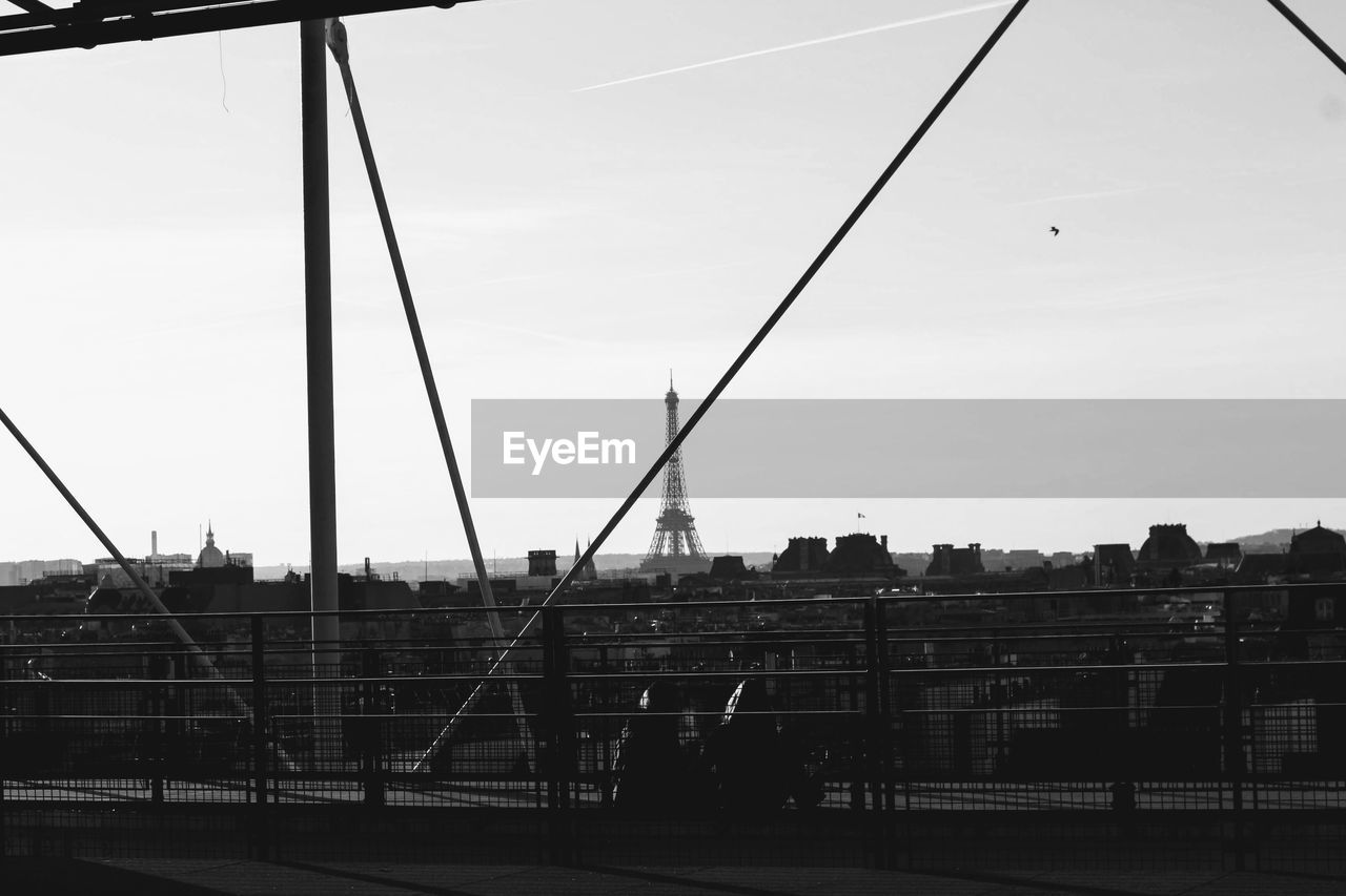 SILHOUETTE PEOPLE ON BRIDGE AGAINST SKY